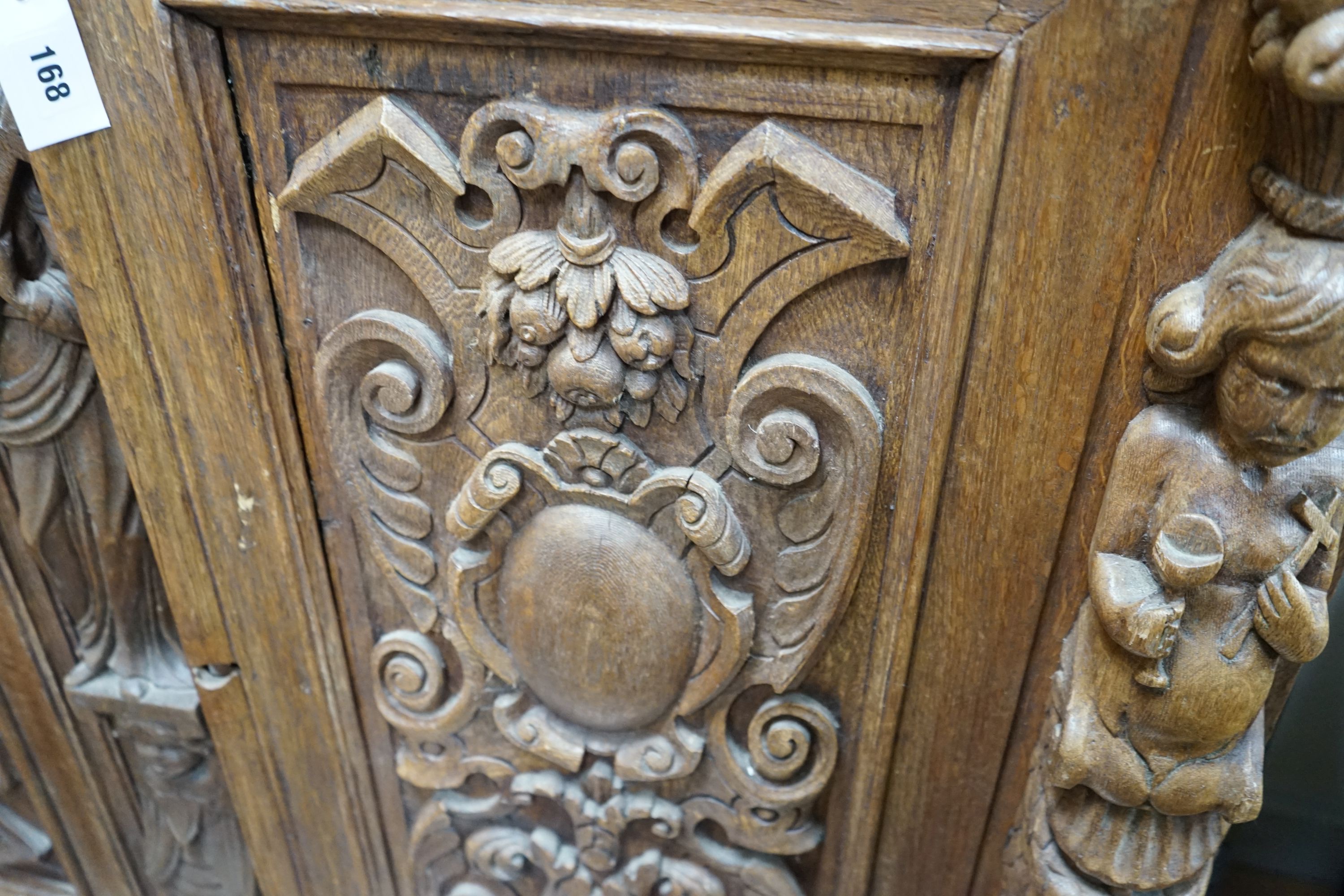 A late 19th / early 20th century Flemish carved oak cabinet section with drawer and pigeon hole interior, width 130cm, depth 52cm, height 107cm